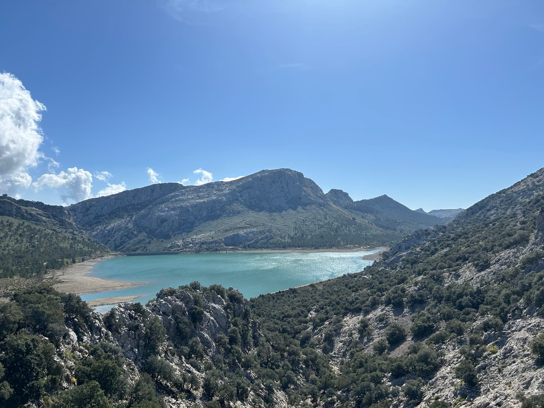 Cala turquesa rodeada de casas y roca